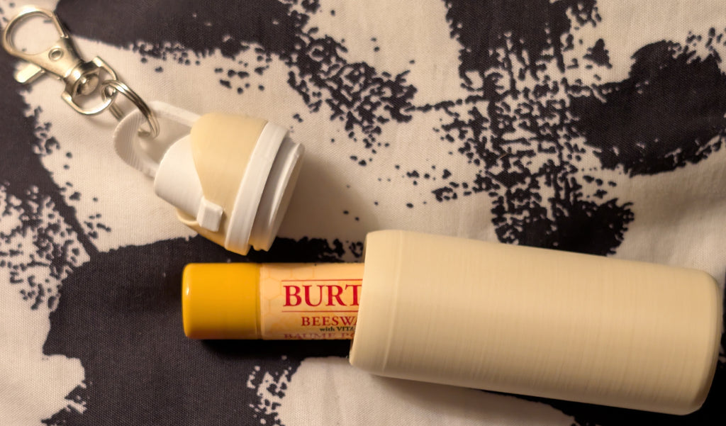 Burt's Bees lip balm on a patterned fabric background