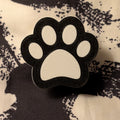 Black and white paw print design on a textured fabric background