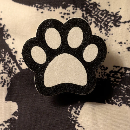 Black and white paw print design on a textured fabric background